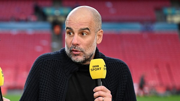 Gary Lineker speaks to Pep Guardiola after Manchester City's victory.