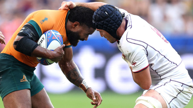 Marika Koroibete of Australia is tackled by Tornike Jalagonia of Georgia.