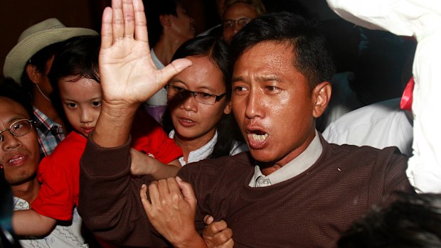 Kyaw Min Yu, a pro-democracy activist talks to journalists as he arrives at Yangon airport welcomed by his wife Nilar Thein, background, also an activist and his daughter after being released from a prison on Jan. 13, 2012, in Yangon. 