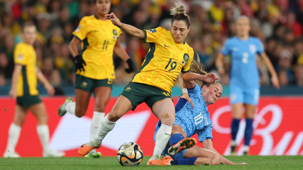 Katrina Gorry of Australia is tackled by Ella Toone of England.