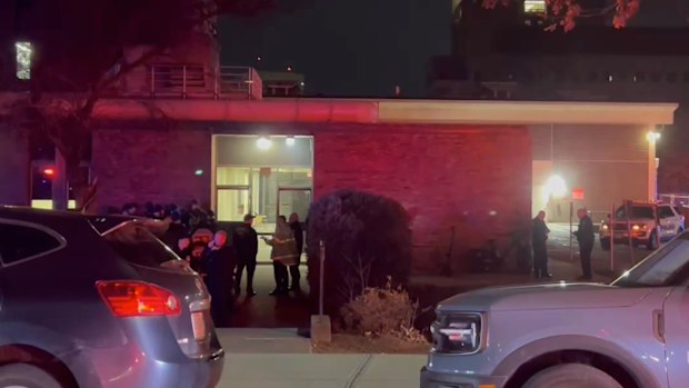 In this image from video, law enforcement officials gather outside the Brown University campus in Providence, R.I., on Saturday, Dec. 13, 2025. (AP Photo/Kimberlee Kruesi)