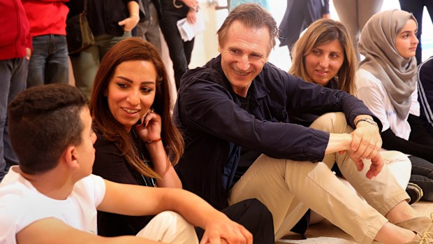 Liam Neeson spends time with young Syrian refugees in Jordan. (AAP)