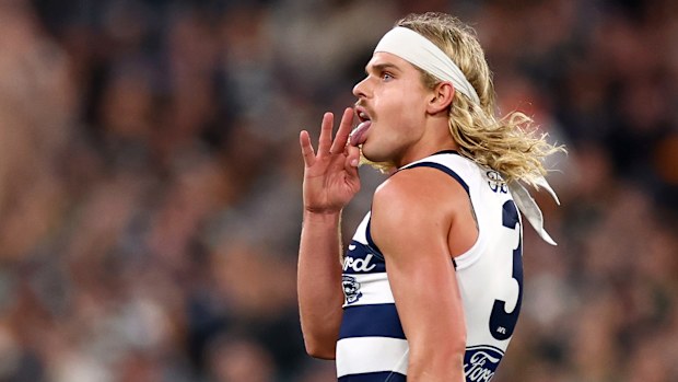 Bailey Smith of the Cats celebrates kicking a goal.