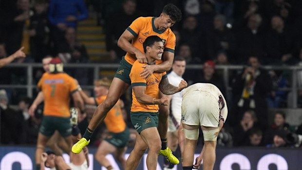 Australia's Len Ikitau and Joseph-Aukuso Suaalii celebrate after Max Jorgensen scores.