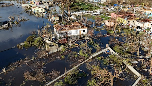 FILE - Debris surrounds damaged homes along the Black River, Jamaica, Thursday, Oct. 30, 2025, in the aftermath of Hurricane Melissa.  (AP Photo/Matias Delacroix, File)