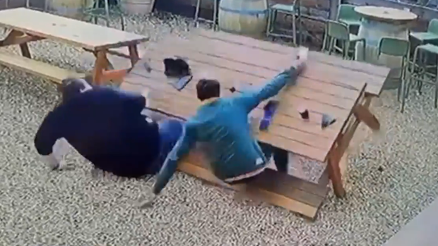 Two friends falling over at the pub.