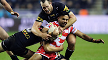 Wigan Warriors' Bevan French is tackled by Jack Cole (left) and Penrith Panthers' Isaah Yeo during the Betfred World Club Challenge match at the DW Stadium, Wigan. Picture date: Saturday February 24, 2024. (Photo by Jess Hornby/PA Images via Getty Images)