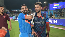 Virta Kohli (left) and Naveen-Al-Huq share a laugh after India's win over Afghanistan.