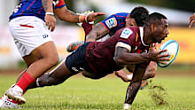 Suliasi Vunivalu of the Reds offloads the ball.