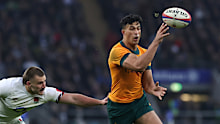 Joseph Suaalii of Australia offloads in a try assist.