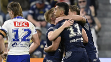 Heilum Luki celebrates with teammates after scoring a try during the round 20 NRL match between the North Queensland Cowboys and the Canterbury Bulldogs.