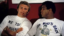 Joe Bugner sits with Muhammad Ali at a press conference in 1975. 