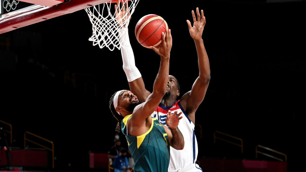 Boomers star Patty Mills attempts a layup against Team USA.