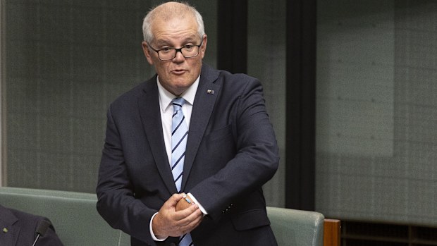 Former Prime Minister Scott Morrison points out his "ScoMo" Taylor Swift friendship bracelet during his valedictory speech