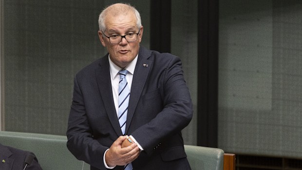 Former Prime Minister Scott Morrison points out his "ScoMo" Taylor Swift friendship bracelet during his valedictory speech