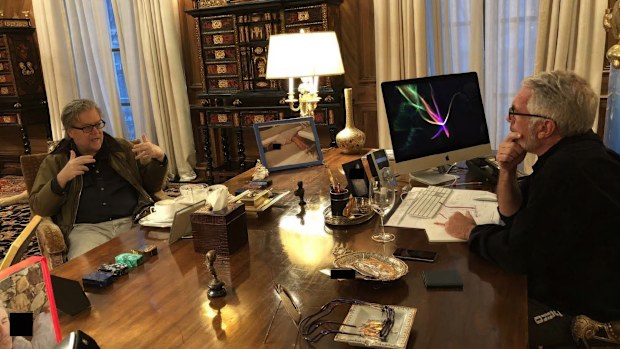 This undated, redacted photo released by Democrats on the House Oversight Committee shows Steve Bannon, left, talking with Jeffrey Epstein. (House Oversight Committee via AP)