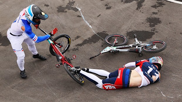 Romain Mahieu of Team France checks on Connor Fields of Team United States after a crash.