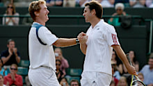 Mark Woodforde and Todd Woddbridge come together after a Wimbledon victory.