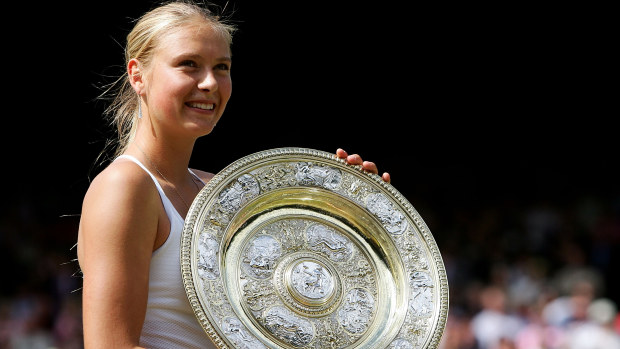 Maria Sharapova holding her first slam trophy at Wimbledon in 2004.