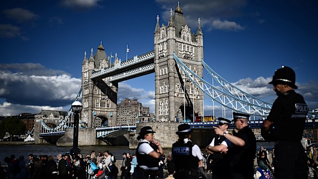 Members of the public stand in the queue near Tower Bridge, as they wait in line to pay their respects to the late Queen Elizabeth II, in London on September 16, 2022, who is lying-in-state at Westminster Abbey. - Queen Elizabeth II will lie in state until 0530 GMT on September 19, a few hours before her funeral, with huge queues expected to file past her coffin to pay their respects. (Photo by Marco BERTORELLO / AFP) (Photo by MARCO BERTORELLO/AFP via Getty Images)