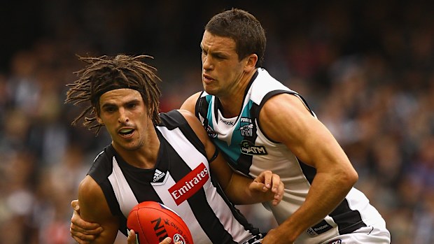Scott Pendlebury, featuring dreadlocks, tackled by Travis Boak in 2011.