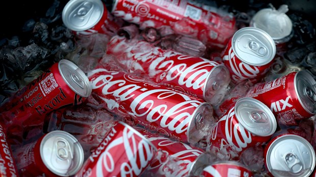 Several Coca-Cola cans in ice.