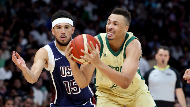 Dante Exum of Australia drives to the basket past Devin Booker of the United States.