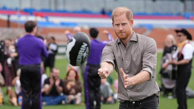 Prince Harry, the Duke of Sussex, punches a sherrin ball during a Western Bulldogs Australian rules football session at the Western Bulldogs HQ at Mission Whitten Oval, in Footscray, a suburb of Melbourne, Australia Wednesday, April 15, 2026. (Jonathan Brady/Pool Photo via AP)