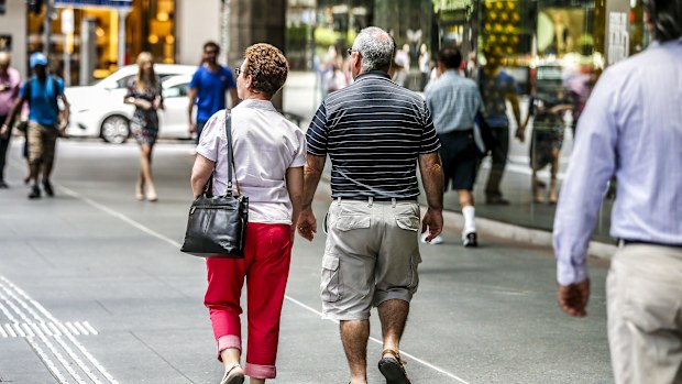 Two old people walk down the street in Brisbane