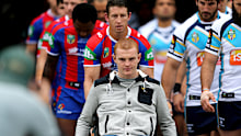 Knights captain Kurt Gidley takes Alex McKinnon onto Hunter Stadium in 2014.
