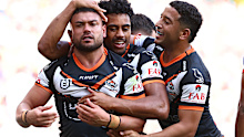 David Nofoaluma of the Wests Tigers celebrates with teammates after scoring a try against the St George Illawarra Dragons.