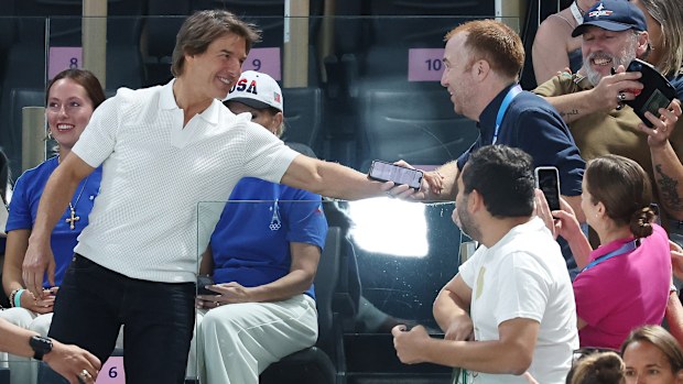 Tom Cruise chats with fans in the crowd at Bercy Arena.