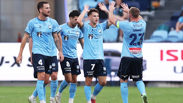 Adrian Segecic celebrates with his Sydney FC teammates after scoring a goal.