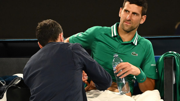 MELBOURNE, AUSTRALIA - FEBRUARY 12: Novak Djokovic of Serbia received medical treatment in his Men's Singles third round match against Taylor Fritz of the United Statesduring day five of the 2021 Australian Open at Melbourne Park on February 12, 2021 in Melbourne, Australia. (Photo by Quinn Rooney/Getty Images)
