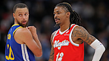 MEMPHIS, TENNESSEE - APRIL 01: Ja Morant #12 of the Memphis Grizzlies looks on at Stephen Curry #30 of the Golden State Warriors during the first half at FedExForum on April 01, 2025 in Memphis, Tennessee. NOTE TO USER: User expressly acknowledges and agrees that, by downloading and or using this photograph, User is consenting to the terms and conditions of the Getty Images License Agreement. (Photo by Justin Ford/Getty Images)