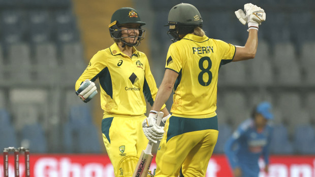 Phoebe Litchfield of Australia celebrates after scoring a 50 with Ellyse Perry.