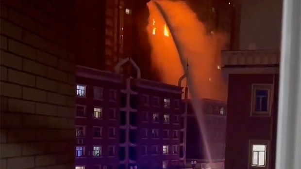 In this image taken from video, firefighters spray water on a fire at a residential building in Urumqi in western China's Xinjiang Uyghur Autonomous Region, Thursday, Nov. 24, 2022. A fire in an apartment building in northwestern China's Xinjiang region has killed several people and injured others, authorities said Friday, in the second major fire accident in the country this week. 