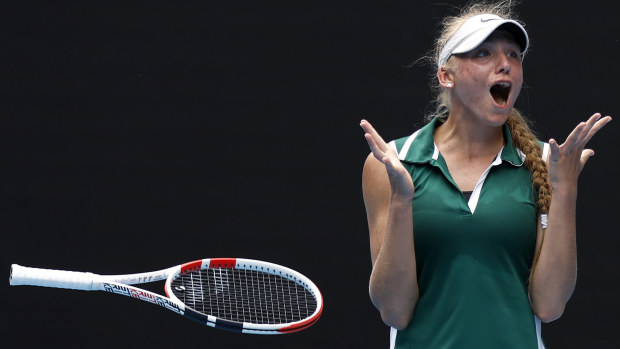 Alina Korneeva throws her racquet in the air after winning the Australian Open girls' final.