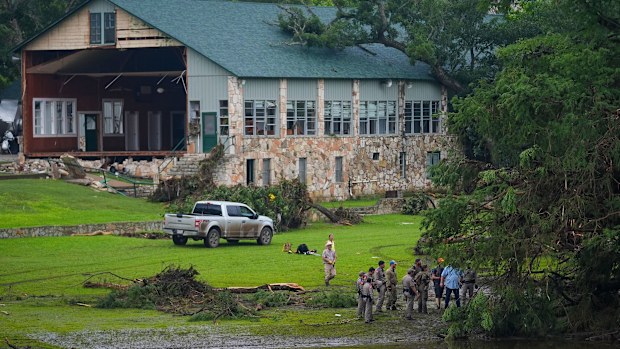 Officials search on the grounds of Camp Mystic on Sunday in Hunt, Texas.