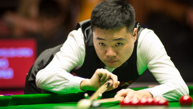 Ding Junhui plays a shot.