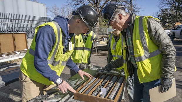 This undated photograph provided by the Denver Museum of Nature and Science shows James Hagadorn and Bob Raynolds examining a drilling core from the City Park core drilling in the parking lot at Denver Museum of Nature and Science.