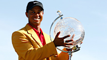 Tiger Woods with the Australian Masters trophy and gold jacket after winning in 2009.