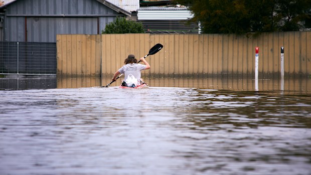 Bodi Fitzsimmons kayaking down the street during the floods in Shepparton, Victoria.