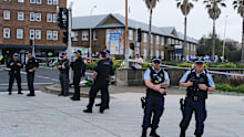 SYDNEY, AUSTRALIA - DECEMBER 15: Police enforce a cordon at Bondi Beach on December 15, 2025 in Sydney, Australia. Police say at least 10 people, including one suspected gunman, were killed and more than a dozen others injured when two attackers opened fire near a Hanukkah celebration at the world-famous Bondi Beach, in what authorities have declared a terrorist incident. (Photo by George Chan/Getty Images)