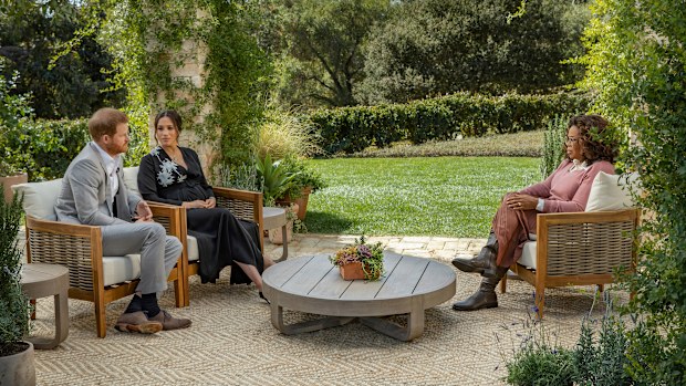 This image provided by Harpo Productions shows Prince Harry, from left, and Meghan, The Duchess of Sussex, in conversation with Oprah Winfrey. (Joe Pugliese/Harpo Productions via AP)