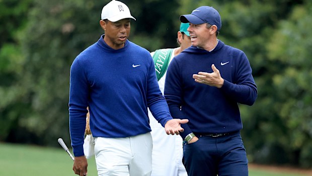 Rory McIlroy and Tiger Woods of the United States walk together on the 11th hole during a practice round prior to the 2023 Masters Tournament at Augusta National. 