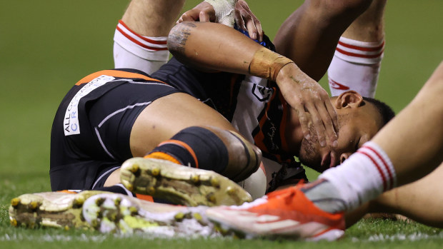 Solomon Alaimalo of the Wests Tigers is injured after a tackle with Zac Lomax of the Dragons during the round 14 NRL match between St George Illawarra Dragons and Wests Tigers at WIN Stadium on June 07, 2024, in Wollongong, Australia. (Photo by Jason McCawley/Getty Images)