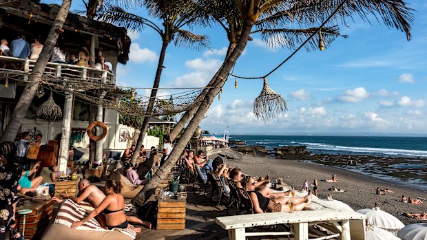 Tourists soak up the sunshine at a beach restaurant in Canggu, Bali.