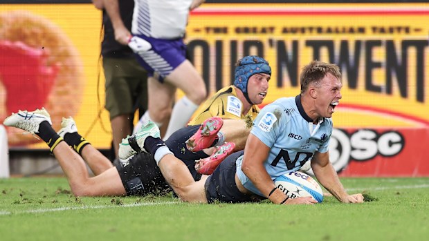 Darby Lancaster of the Waratahs celebrates scoring a try.