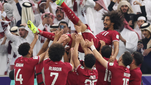 Akram Afif of Qatar celebrates with team mates following their sides victory in the AFC Asian Cup final match between Jordan and Qatar at Lusail Stadium on February 10, 2024 in Lusail City, Qatar. (Photo by Robert Cianflone/Getty Images)